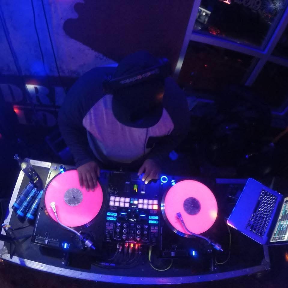 Overhead view of DJ John Styles at turntables with pink vinyl